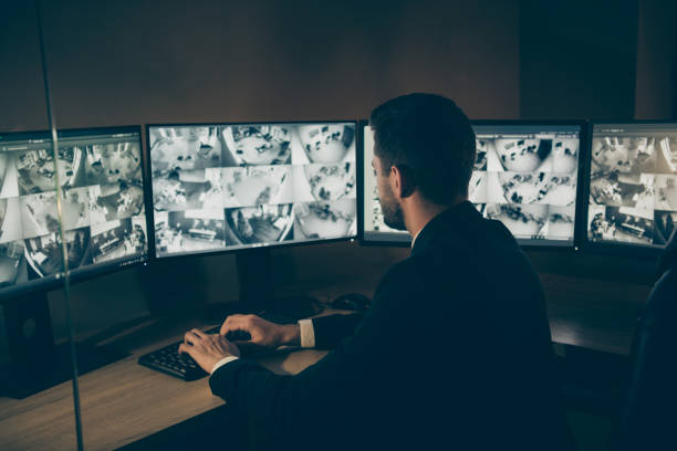 Profile side view portrait of his he nice serious professional man qualified expert, safeguard supervising customers online safety remote panel night shift at workplace workstation